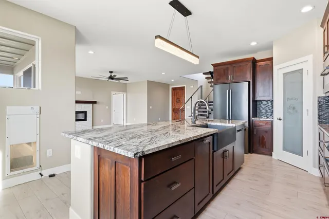a kitchen with a stove a refrigerator and a sink