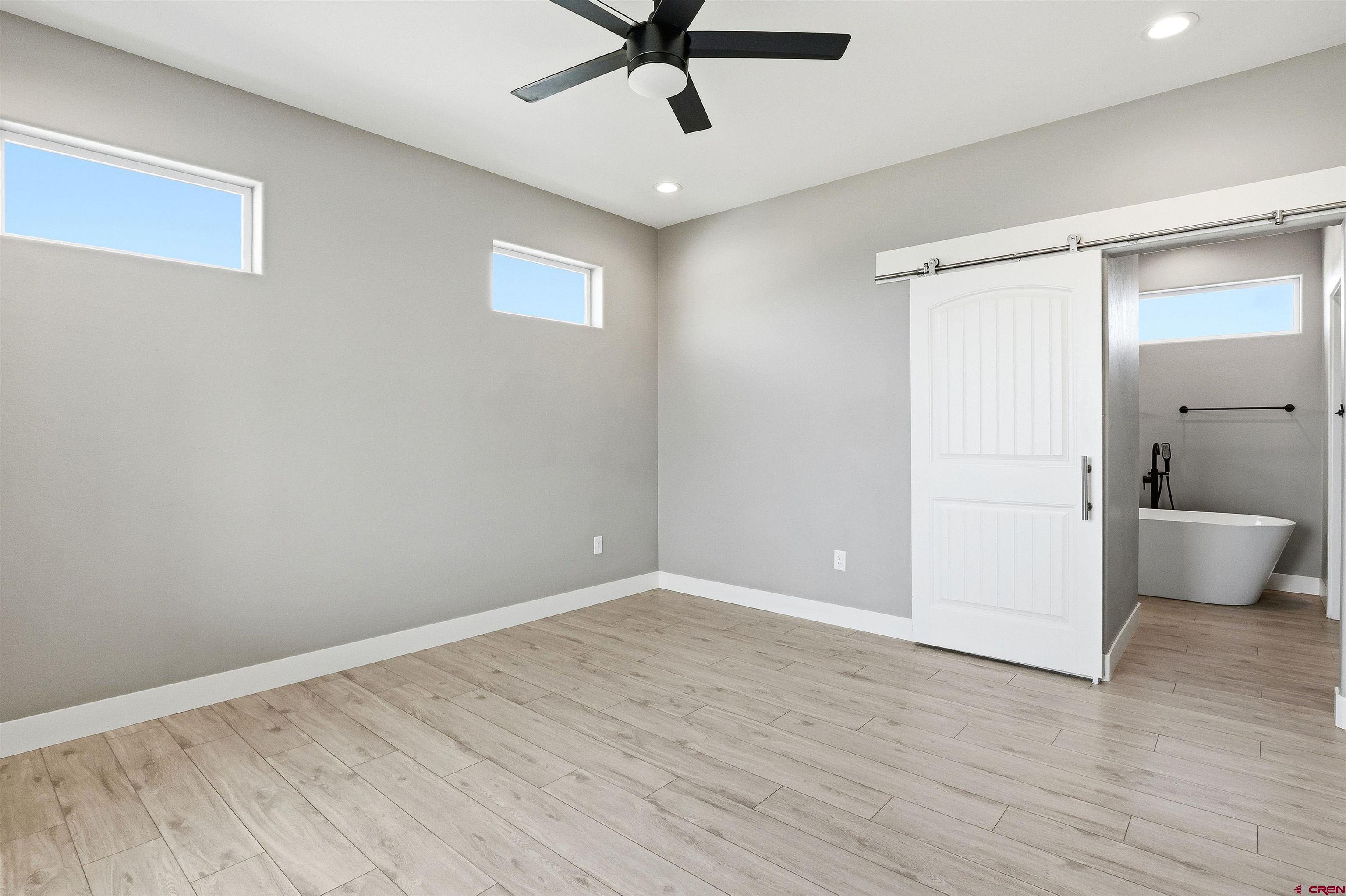 3614 Ridgeline Drive Montrose, CO 81401 - Photo 23 of 45 wooden floor in an empty room with a window