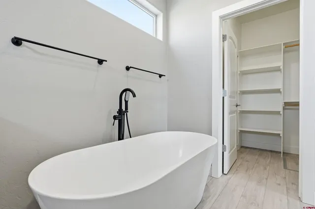 a bathroom with a bathtub and a shower
