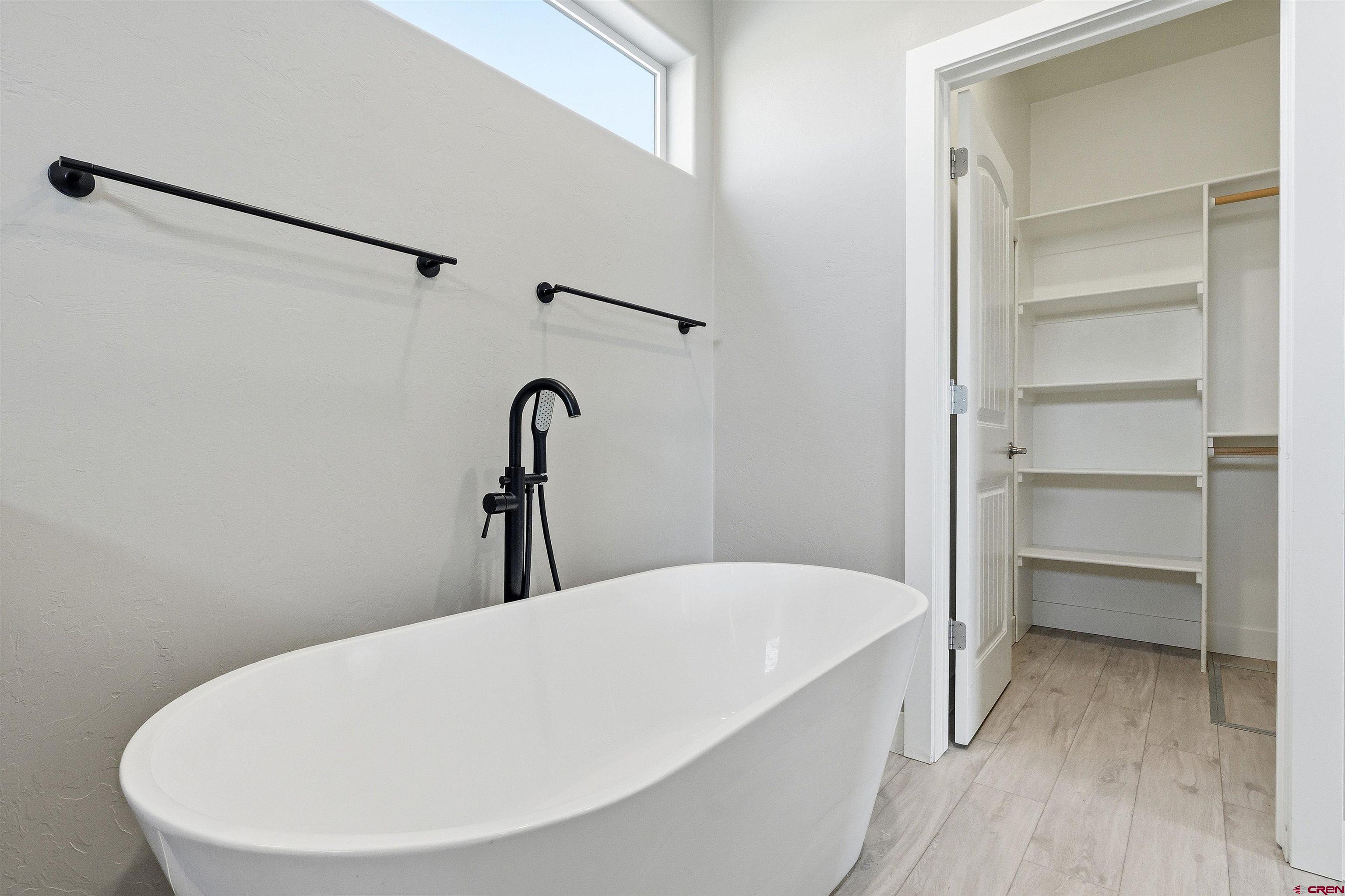 3614 Ridgeline Drive Montrose, CO 81401 - Photo 25 of 45 a bathroom with a bathtub and a shower