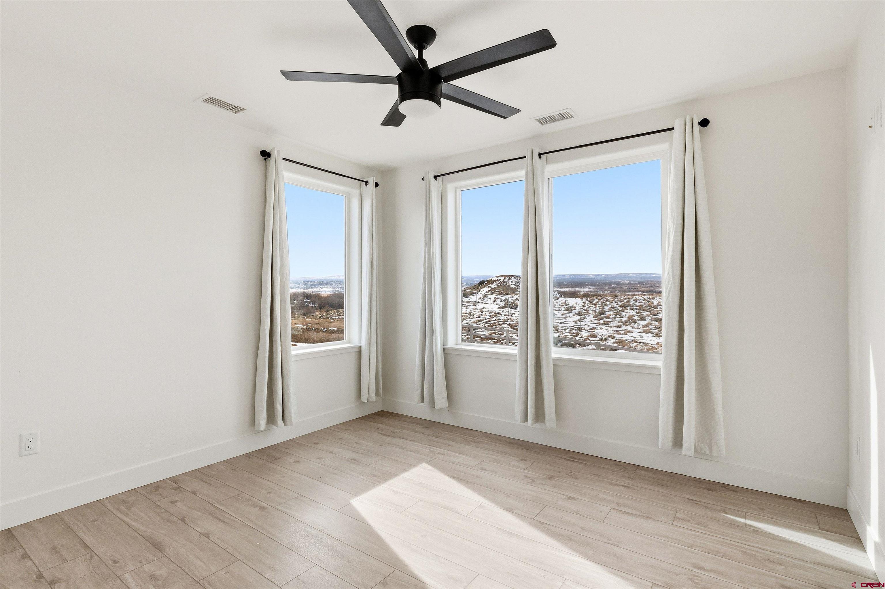 3614 Ridgeline Drive Montrose, CO 81401 - Photo 29 of 45 an empty room with windows and closet