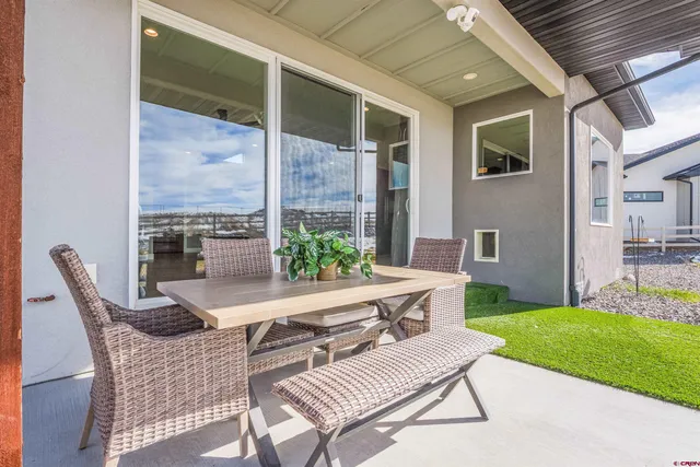 a view of a patio with lawn chairs