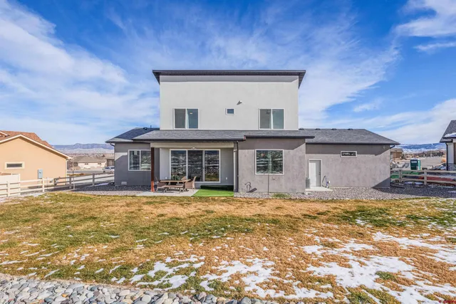 a view of a house with a large pool and a yard