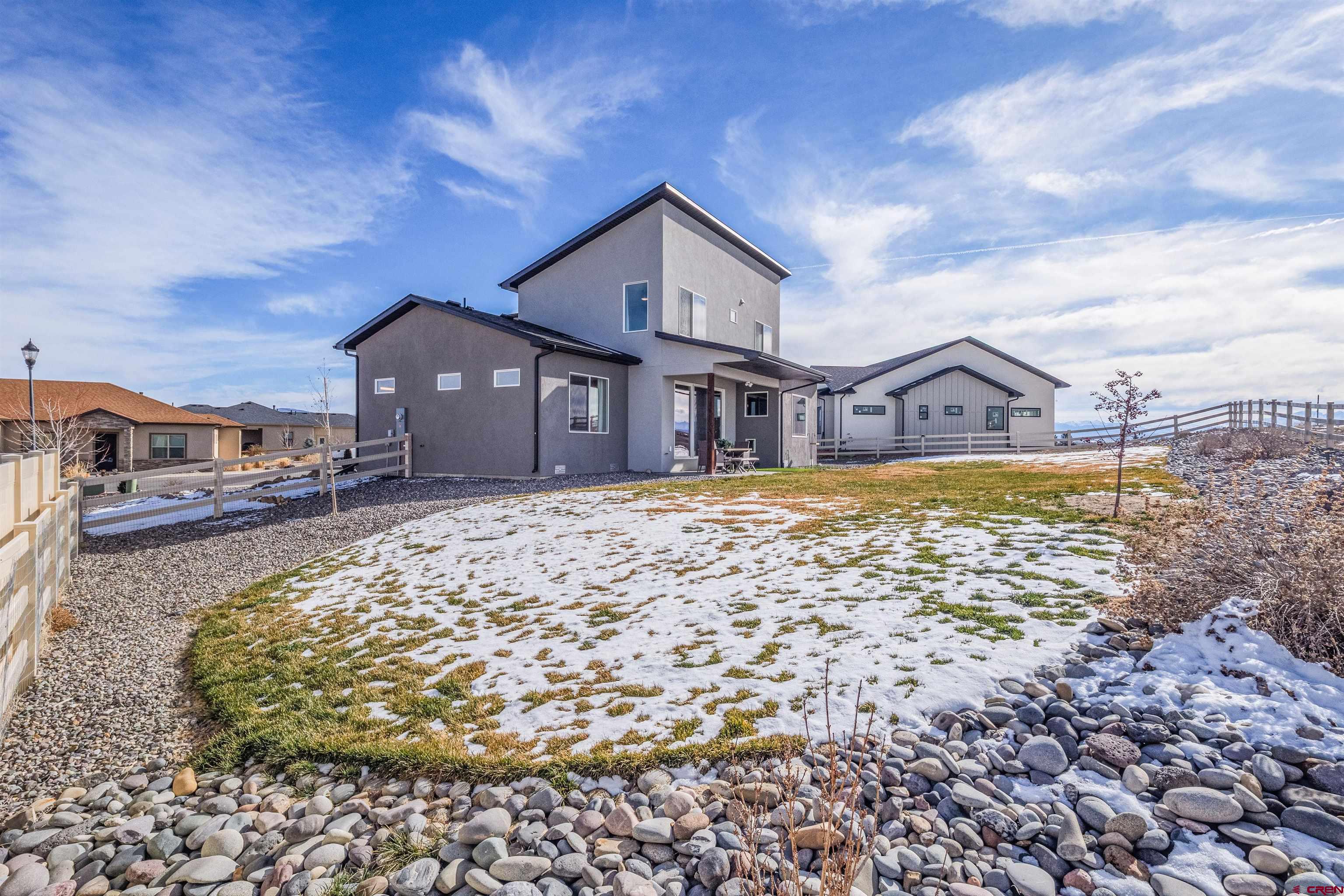 3614 Ridgeline Drive Montrose, CO 81401 - Photo 40 of 45 a view of a house with a large pool and a yard