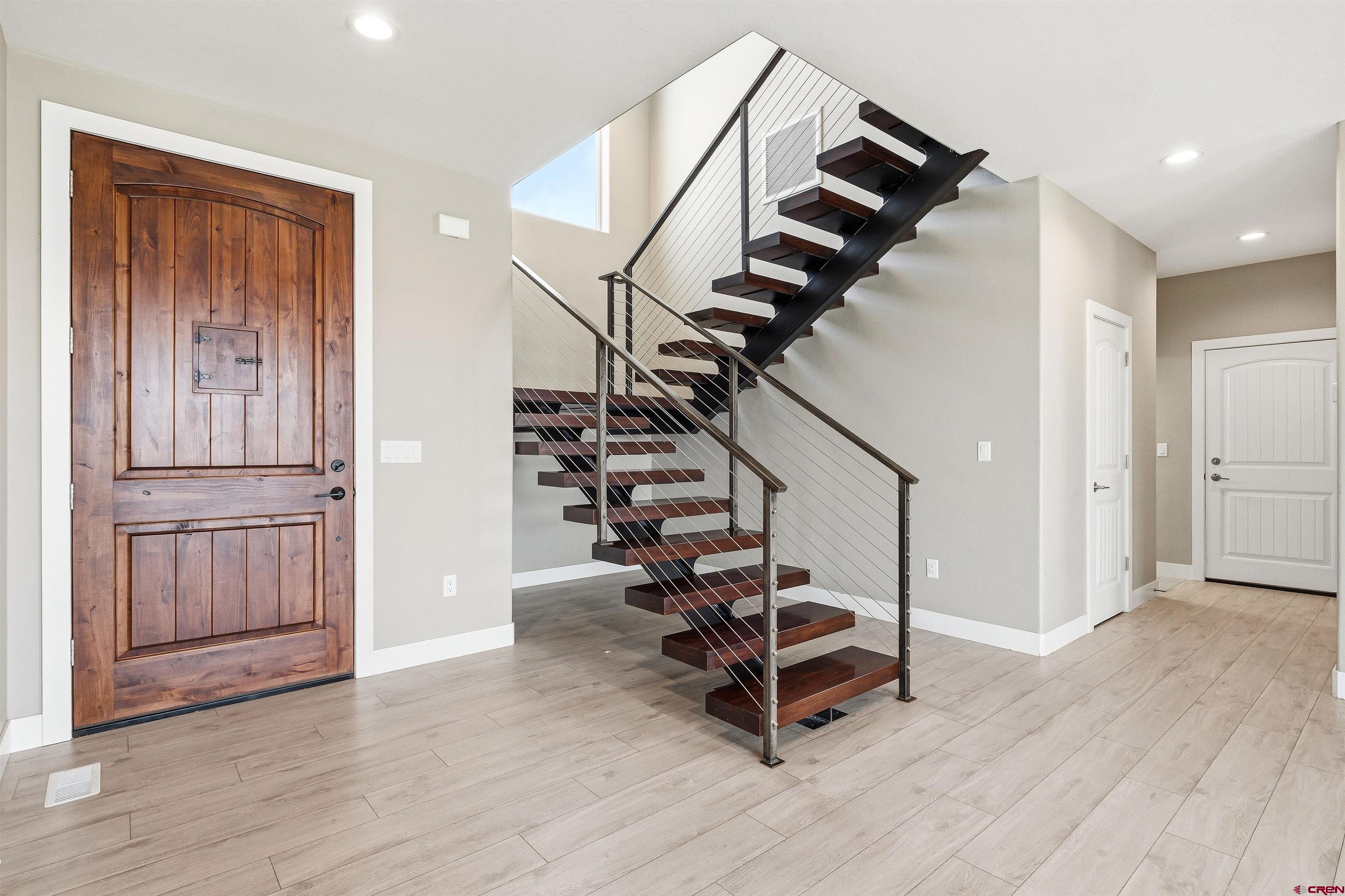 3614 Ridgeline Drive Montrose, CO 81401 - Photo 6 of 45 a view of entryway with wooden floor and stairs