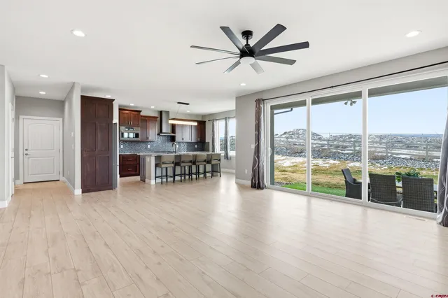 a view of a livingroom with furniture wooden floor and window