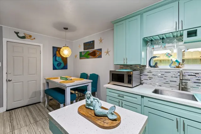 a kitchen with a wooden floor and breakfast area
