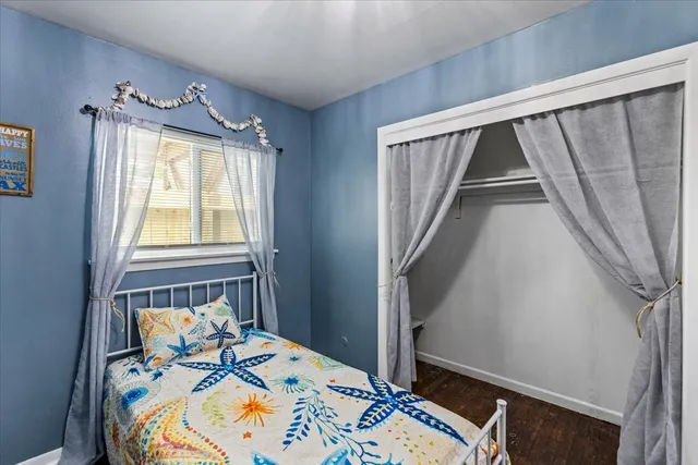 a bed sitting in a bedroom next to a window