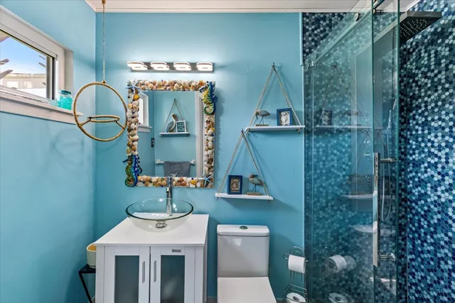 a bathroom with a sink mirror and toilet