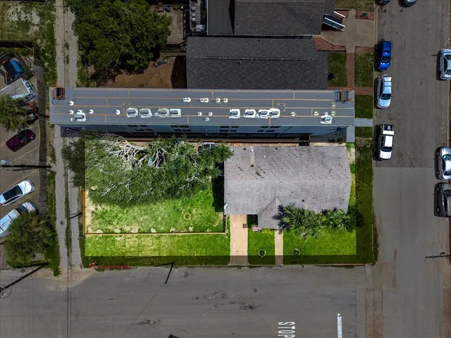 an aerial view of a house with a street