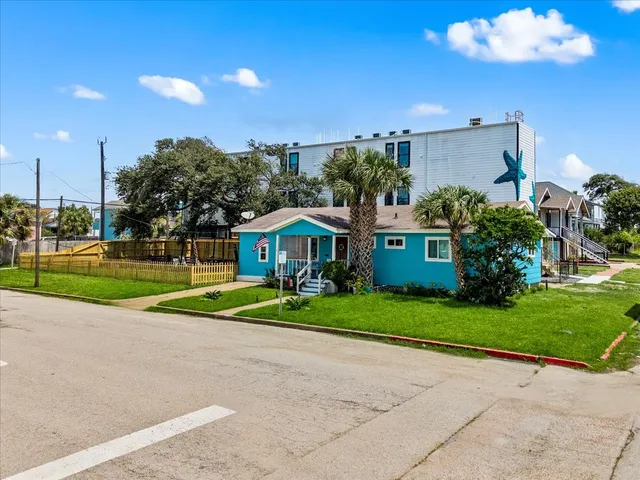 a view of a house with a yard and plants