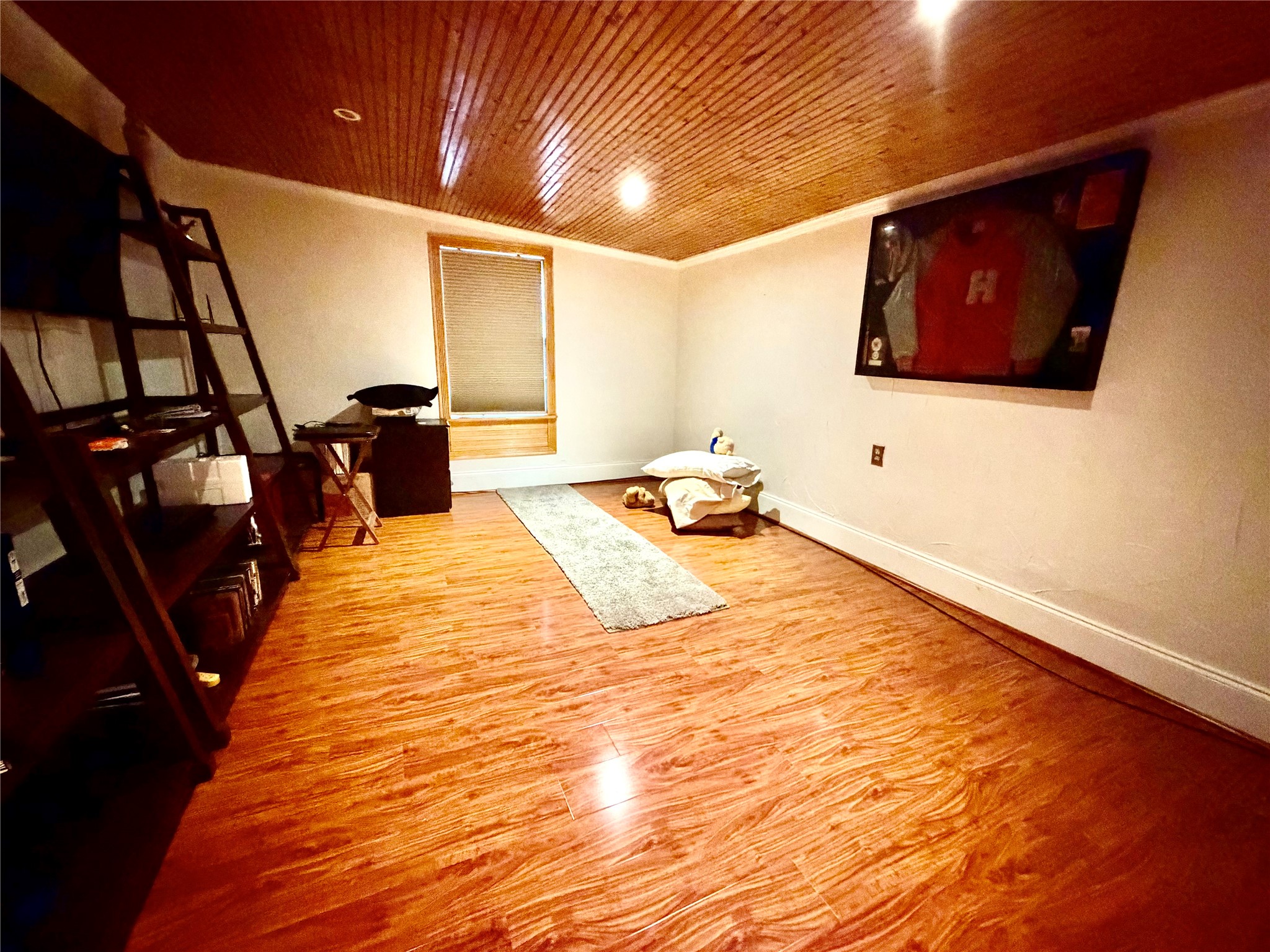 2609 Bevis Street Houston, TX 77008 - Photo 11 of 28 a bedroom with a bed and wooden floor