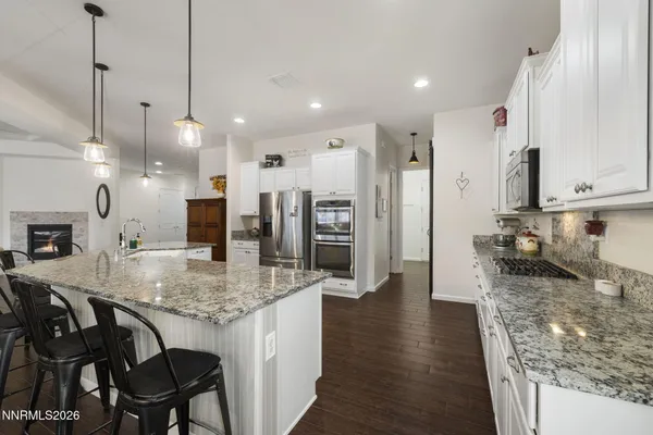 a kitchen with stainless steel appliances granite countertop a refrigerator and a sink