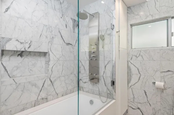 a bathroom with a bathtub and a shower