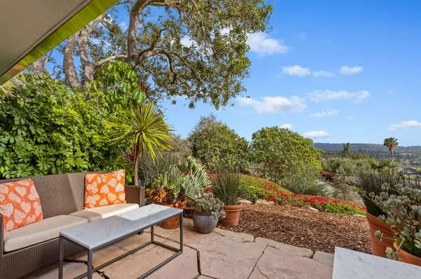 a backyard of a house with table and chairs