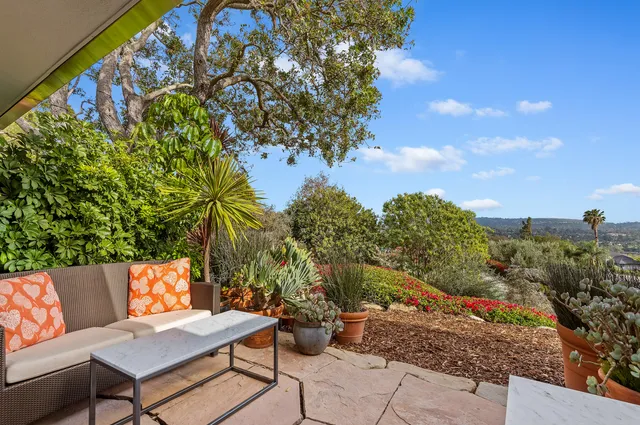 a backyard of a house with table and chairs