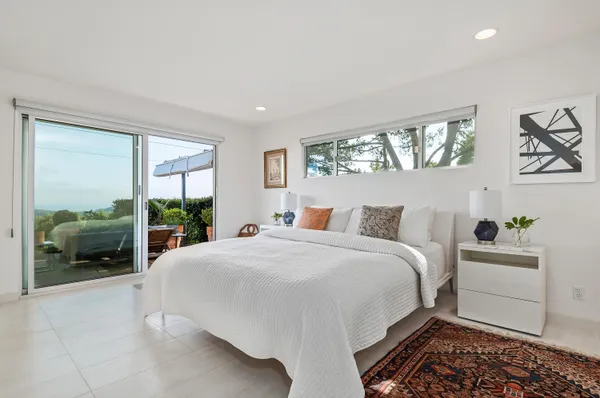 a spacious bedroom with a bed and a large window