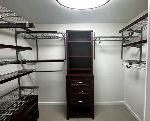 a bathroom with a glass shower door and a window