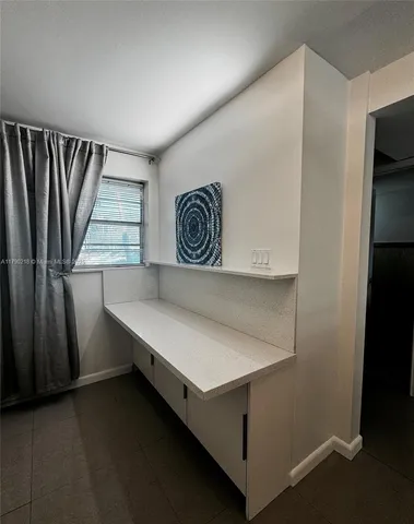 a room with a wooden floor and a window