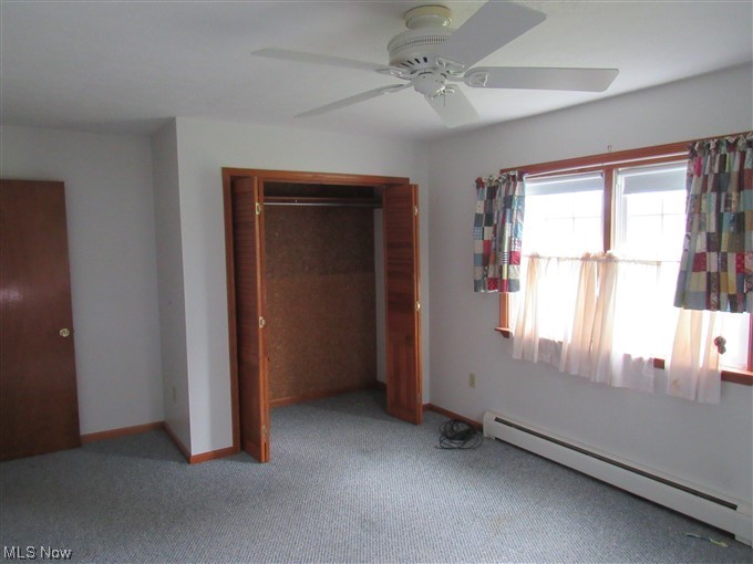2189 Sentinel Road Dorset, OH 44032 - Photo 19 of 28 Bedroom featuring a baseboard heating unit, light carpet, and ceiling fan