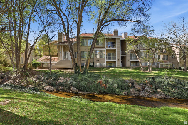 View of property with a water view