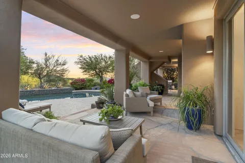 a backyard of a house with table and chairs