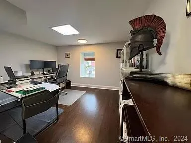 a view of a workspace with furniture and a window