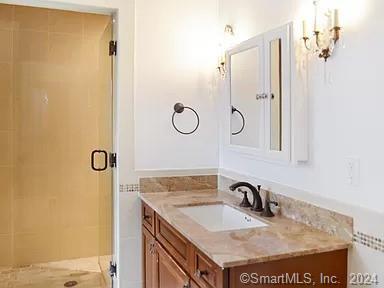 282 Bruce Park Avenue, Unit 2 Greenwich, CT 06830 - Photo 18 of 25 a bathroom with a granite countertop sink and a mirror