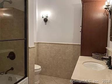 282 Bruce Park Avenue, Unit 2 Greenwich, CT 06830 - Photo 19 of 25 a bathroom with a sink a toilet and shower