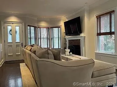 a living room with furniture fireplace and flat screen tv