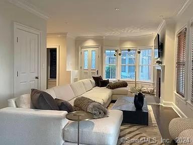 282 Bruce Park Avenue, Unit 2 Greenwich, CT 06830 - Photo 4 of 25 a living room with furniture and large windows