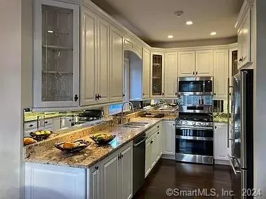 a kitchen with a stove a sink and a refrigerator