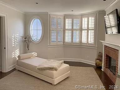 282 Bruce Park Avenue, Unit 2 Greenwich, CT 06830 - Photo 7 of 25 a spacious bedroom with a bed a fireplace and a large window