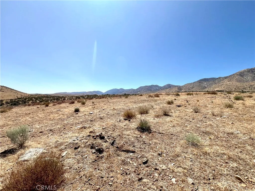 113 Juniper Mesa Road Juniper Hills, CA 93543 - Photo 4 of 15 a view of a lake with a mountain in the background