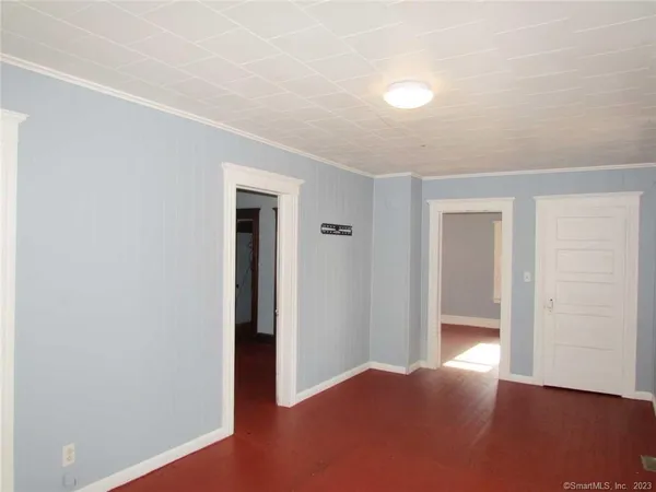 an empty room with wooden floor and closet