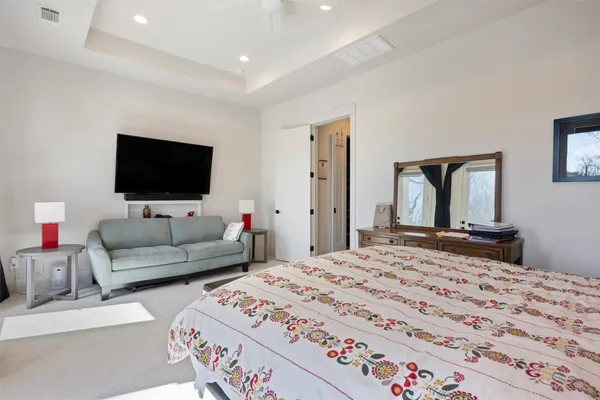 a bedroom with a bed and a large window