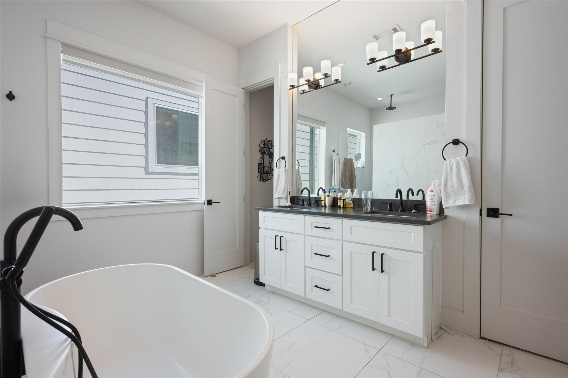 1136 Adele Street Houston, TX 77009 - Photo 21 of 28 a bathroom with a tub sink and mirror