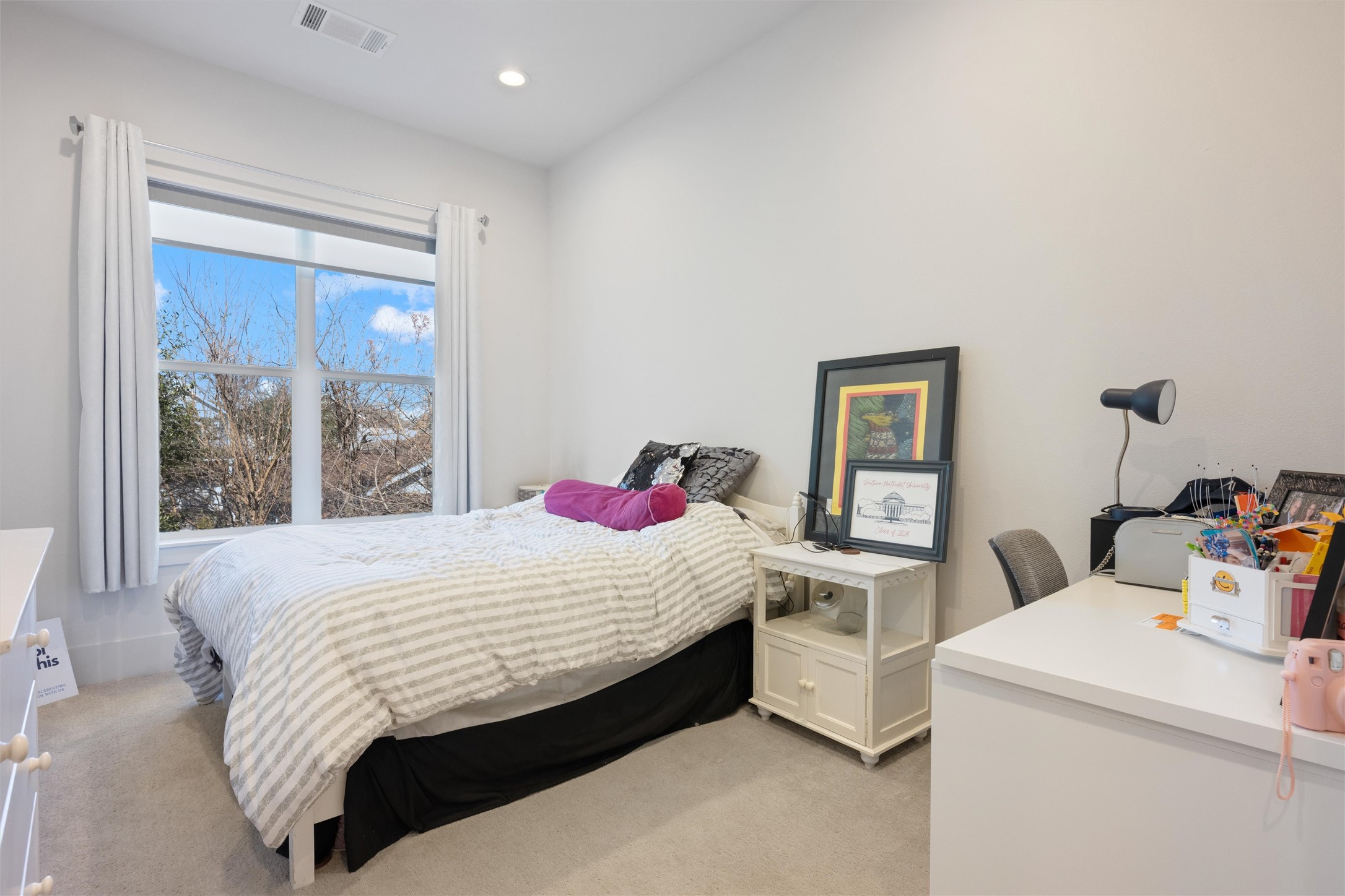 1136 Adele Street Houston, TX 77009 - Photo 23 of 28 a bed sitting in a bedroom next to a window