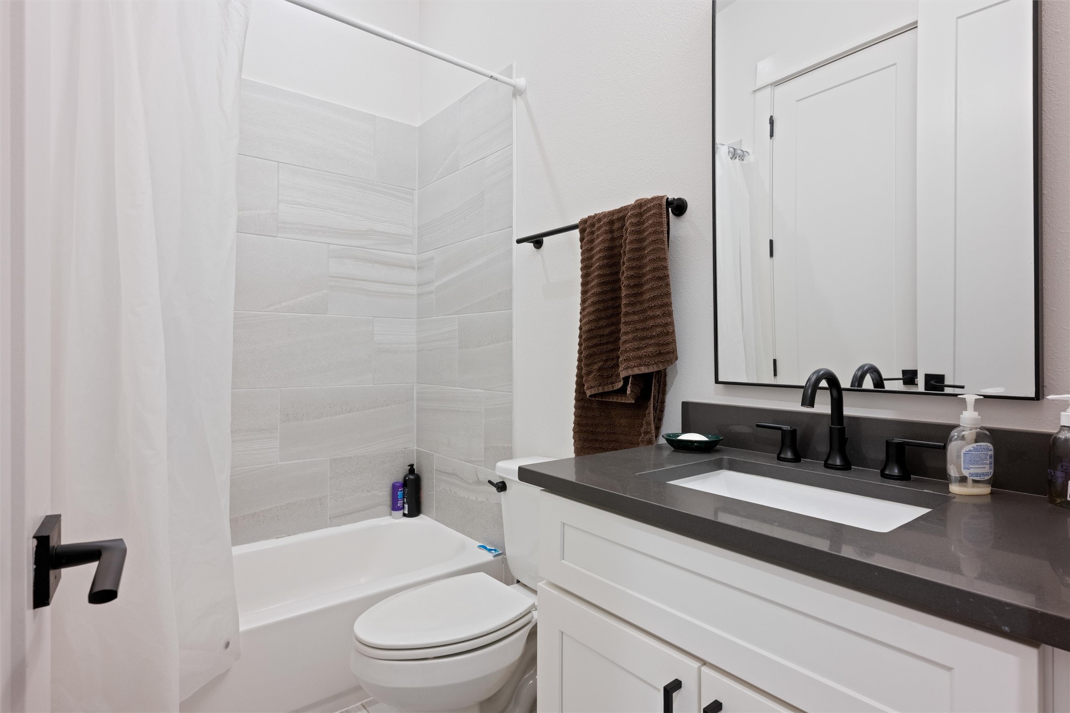 1136 Adele Street Houston, TX 77009 - Photo 24 of 28 a bathroom with a granite countertop sink toilet and shower