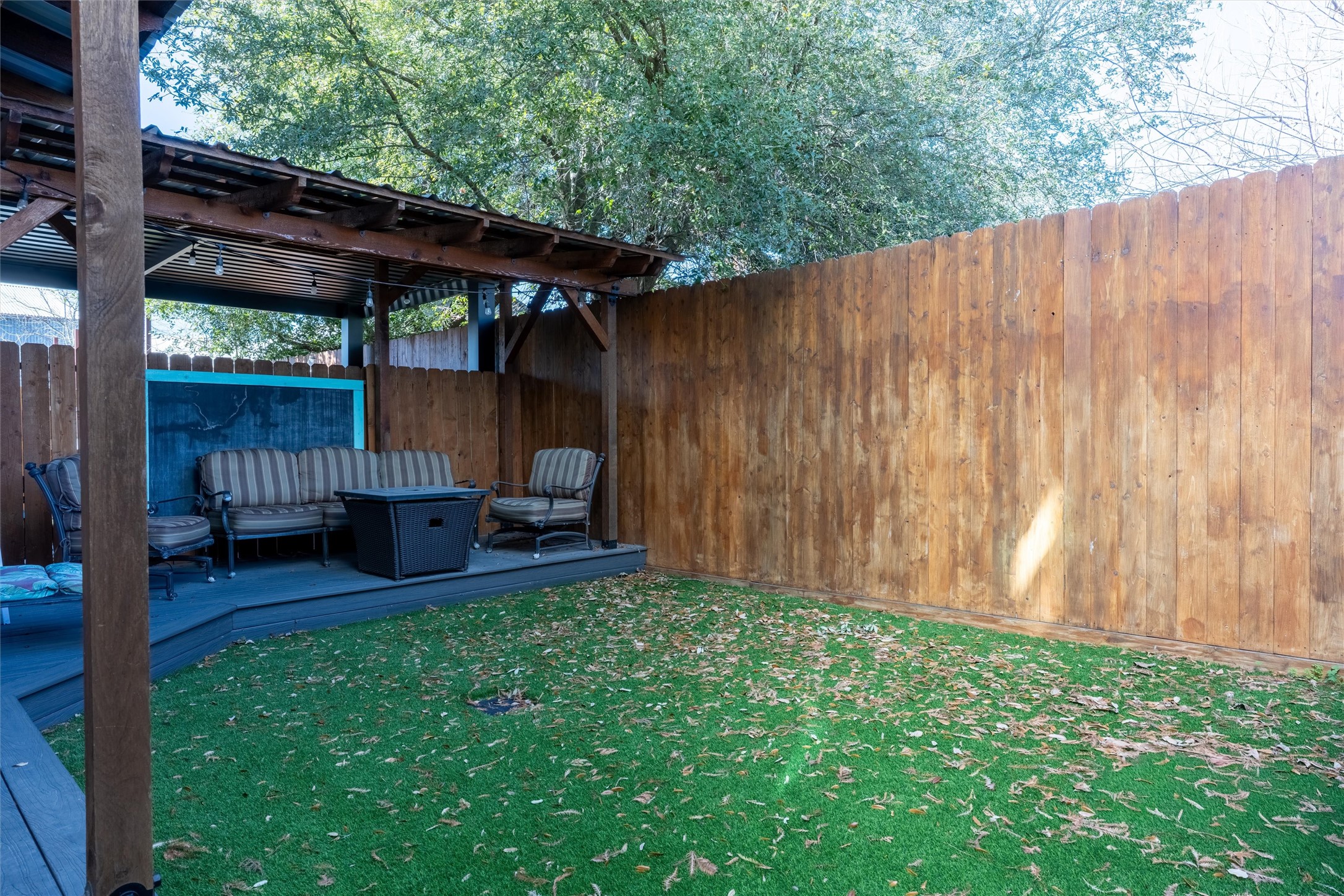 1136 Adele Street Houston, TX 77009 - Photo 28 of 28 a view of backyard with table and chairs and a large tree