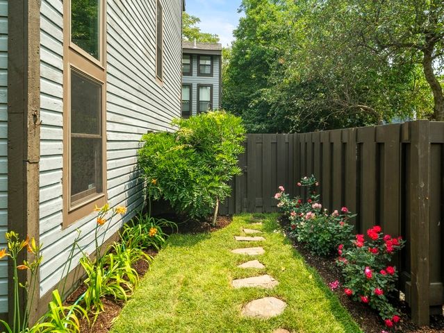 a view of a backyard with plants and flowers