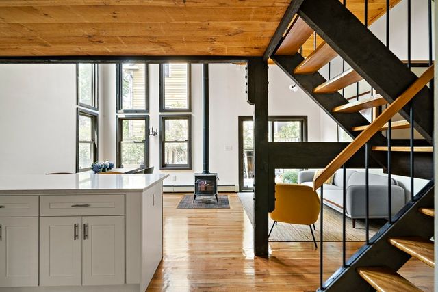 a living room with table chairs and a stove