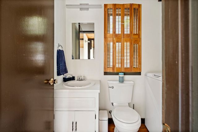 a bathroom with a sink toilet and mirror