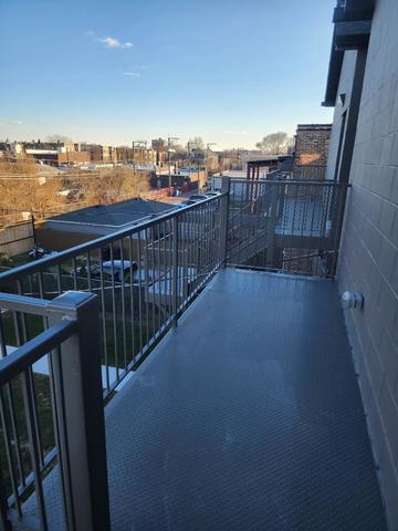 4625 South Michigan Avenue, Unit 2 Chicago, IL 60653 - Photo 18 of 21 a view of a balcony with wooden floor