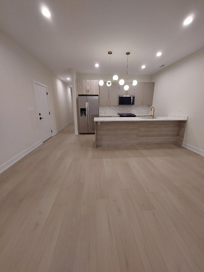 4625 South Michigan Avenue, Unit 2 Chicago, IL 60653 - Photo 5 of 21 a view of a big room with a chandelier