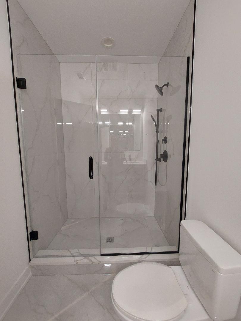 4625 South Michigan Avenue, Unit 2 Chicago, IL 60653 - Photo 7 of 21 a bathroom with a toilet and a shower