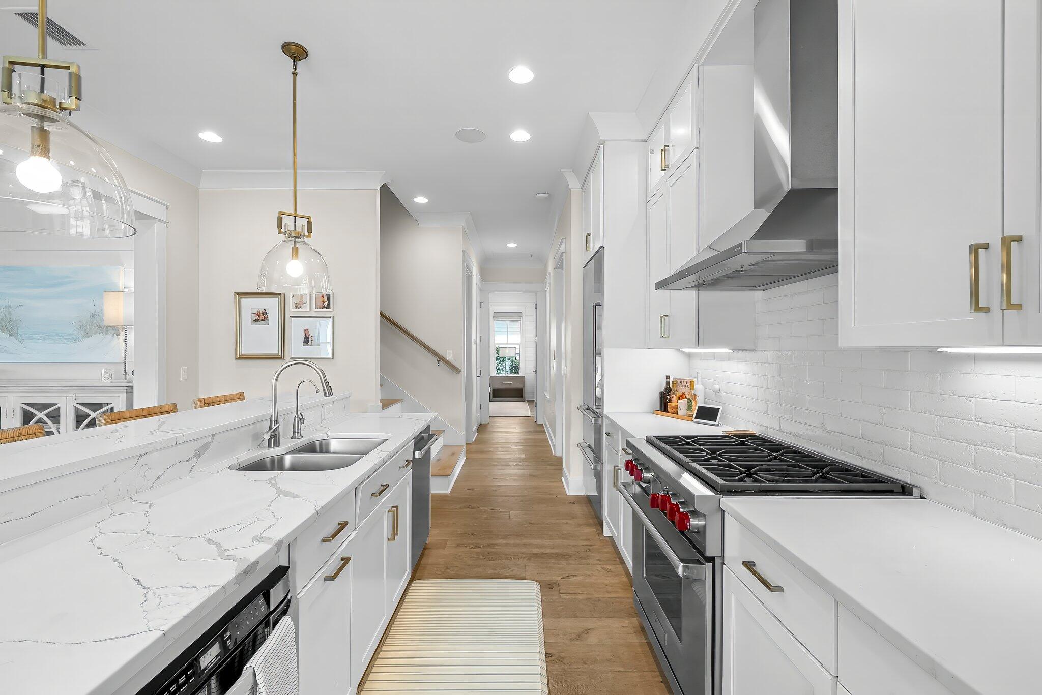 146 Trailhead Drive Inlet Beach, FL 32461 - Photo 12 of 74 a kitchen with kitchen island a stove a sink a refrigerator and chairs