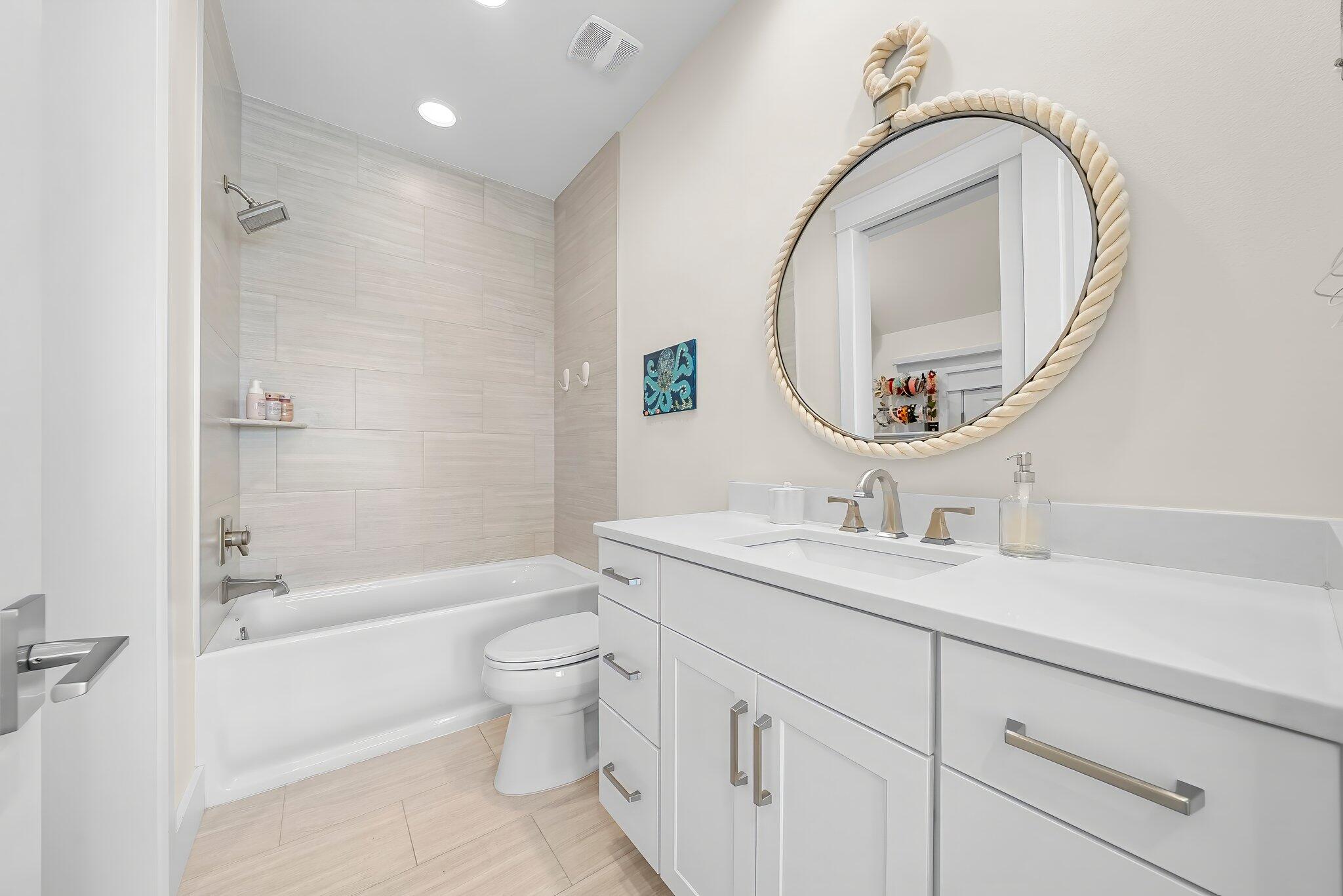 146 Trailhead Drive Inlet Beach, FL 32461 - Photo 32 of 74 a bathroom with a granite countertop toilet a sink and a mirror