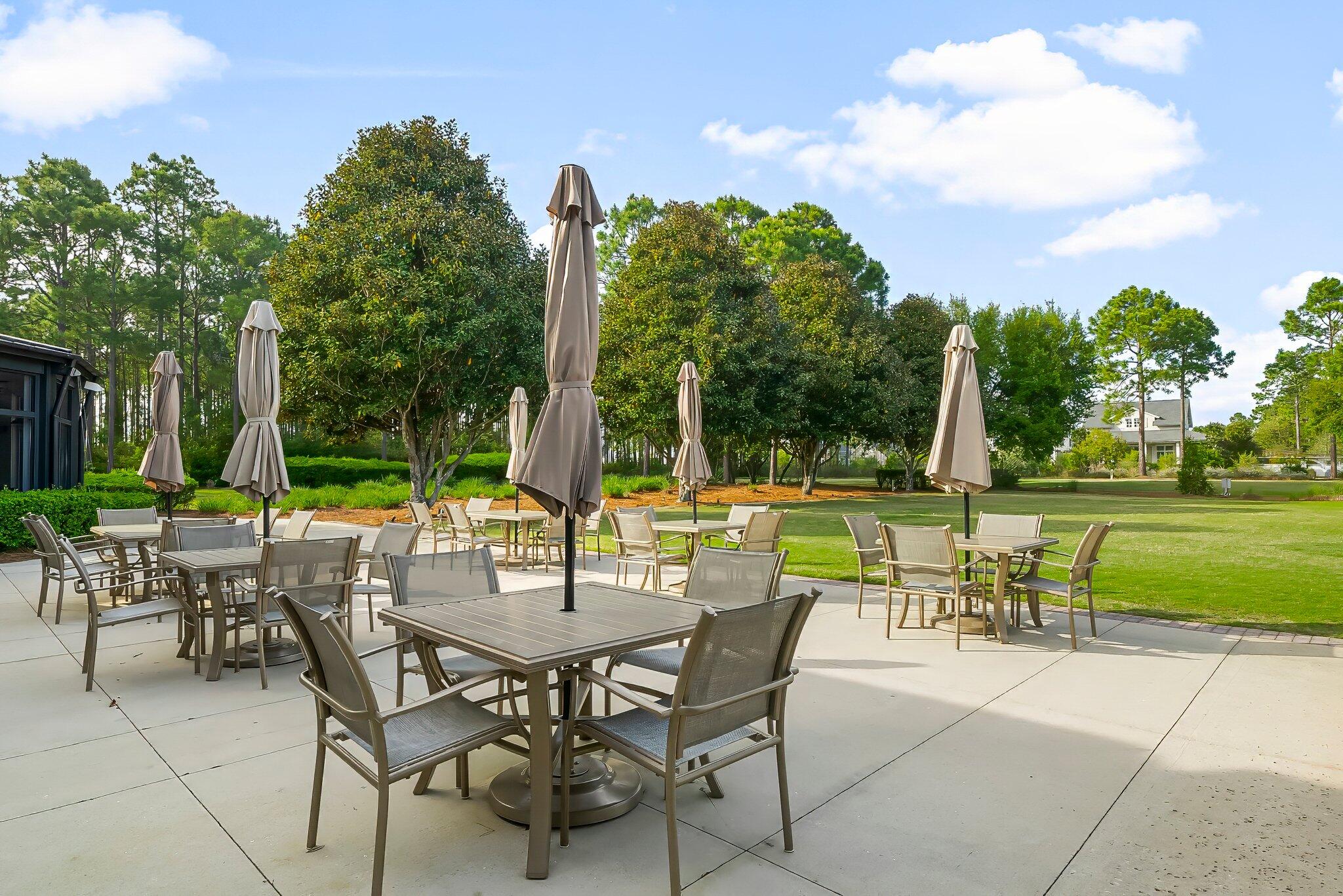 146 Trailhead Drive Inlet Beach, FL 32461 - Photo 52 of 74 a view of a chairs and table in the patio and a yard