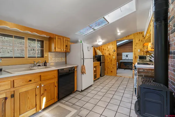 a kitchen that has a sink and a stove in it